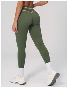 Macro detail of olive green yoga pants showing white V-line stitching and soft brushed fabric