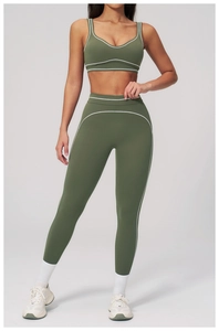 Close-up of contrast piping detail on olive green high-waisted yoga pants and sports bra