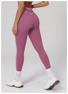 Detail of high-waisted yoga leggings with white contrast piping and V-shape back seam