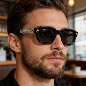 Detail view of square black acetate sunglasses with silver metal arrow on temple