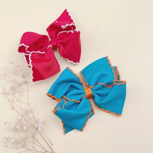 Macro shot of large grosgrain ribbon hair bows with crochet edges for girls
