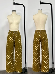 Front and back view of olive green polka dot high-waisted wide-leg denim trousers