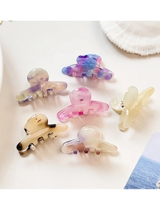 Close-up of a 6-piece mini acetate hair claw clip set with marble and amber textures