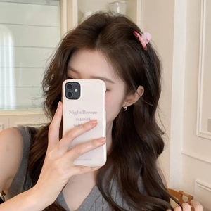 Pink marble acetate hair claw clip worn by a model with long hair in a home setting
