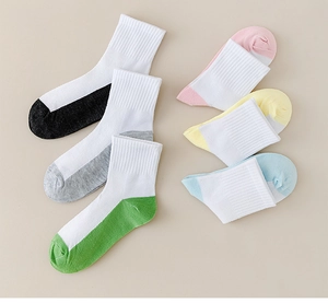 Detail of six pairs of breathable white mesh cotton crew socks with colorful heels and toes