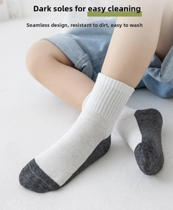 Detail of kids white crew socks with dark reinforced sole and breathable ribbed cotton mesh