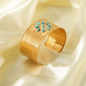 Detailed view of bohemian gold-plated cuff bracelet featuring a turquoise sunflower center