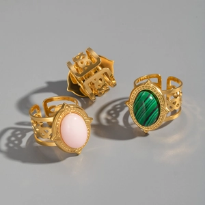 Detail of vintage gold open rings set featuring oval turquoise and pink stones