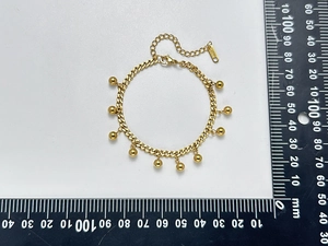 Detailed top view of 18K gold-plated steel bracelet with beads and measurement scale