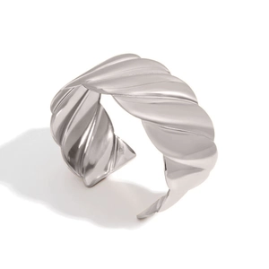 Detailed view of silver-toned wide croissant cuff bracelet with polished wavy texture
