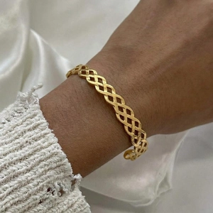 18K gold plated stainless steel open bangle featuring a hollow woven wave pattern