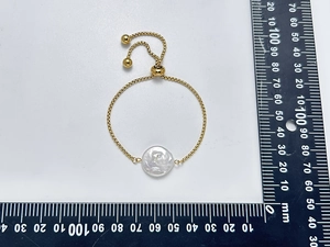 Adjustable stainless steel chain bracelet with a large white baroque pearl and scale