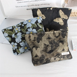 Three-piece set of vintage jacquard makeup bags with intricate floral embroidery details