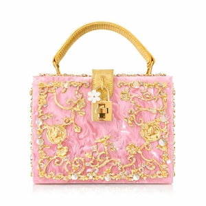 Exquisite pink acrylic clutch with intricate golden hollow carvings and crystal inlay