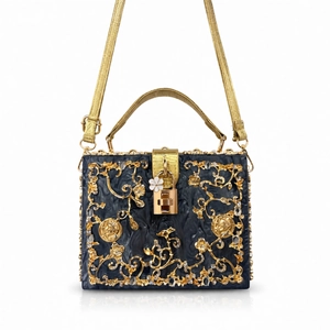 Close-up of evening bag featuring intricate gold floral filigree and padlock detail