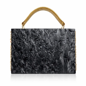 Detailed view of black marble acrylic evening bag with gold floral accents and leather handle