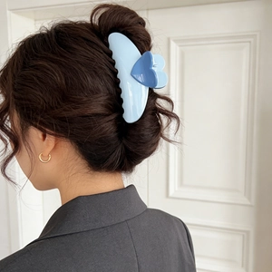Large blue heart hair claw clip for women, stylish hair clip shown in use on back of hair