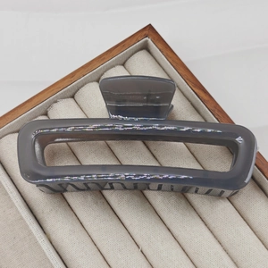 Detail of 13cm translucent smoky grey large hair claw clip in a velvet jewelry box