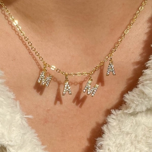 Gold stainless steel MAMA necklace with sparkling zircon pendant worn on a female neck