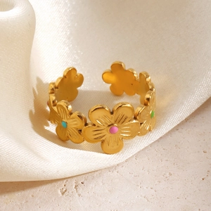 Golden floral stainless steel ring with colorful enamel accents on white silk