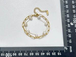 Detail of double-layer stainless steel gold chain with natural freshwater pearls
