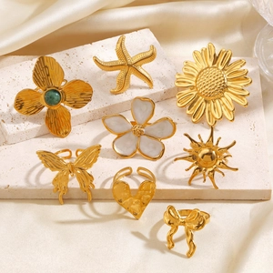 Set of 8 gold stainless steel rings featuring starfish, sunflower, and butterfly designs