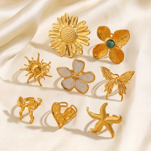 Set of 8 gold stainless steel rings featuring sunflower, butterfly, and heart designs