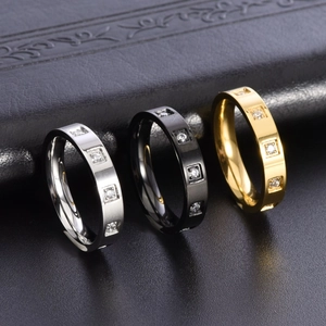 Three-piece stackable minimalist rings in silver, black, and 18K gold finishes with crystals