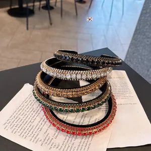 Close-up of sparkling rhinestone headbands in multiple colors on vintage paper