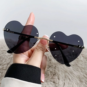 Fashionable heart-shaped frameless sunglasses with dark lenses and gold metal temples