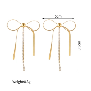 Golden bow tassel earrings with white rhinestones on minimalist stainless steel studs