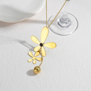 Minimalist gold flower pendant necklace with floral charms on a sleek snake chain