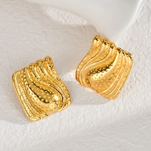 Irregular golden geometric square earrings with wavy texture and embossed dot patterns