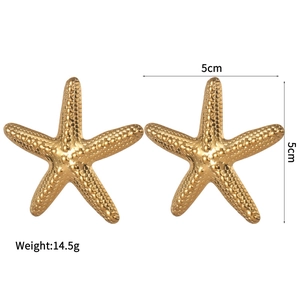 Macro detail of gold starfish earrings with irregular texture and size dimensions