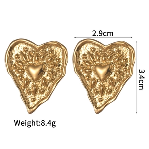 Detailed view of vintage gold heart earrings with hammered texture and 3.4cm size