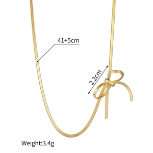 Polished gold bow necklace detail with dimensions 41+5cm length and 2.2cm width
