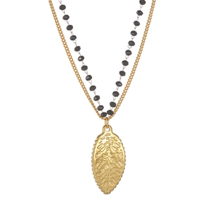 Detailed view of 18k gold starfish leaf pendant with black faceted beaded necklace chain
