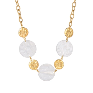 Close-up of stainless steel necklace with sunburst gold discs and white resin pendants