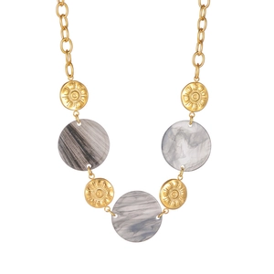 Close-up of golden sunray medallions and grey marble pendants on a metal chain