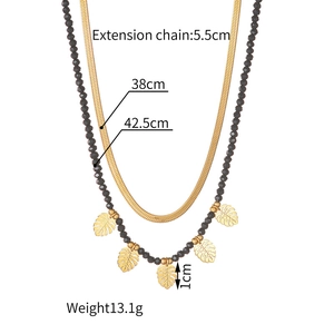 Detailed view of 18k gold layered necklace dimensions with bead and leaf charms