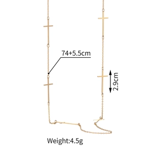 Detailed view of a gold cross necklace with measurements 74+5.5cm and 2.9cm pendant size