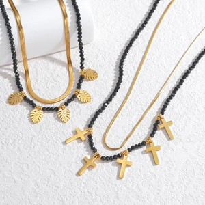 Double-layered 18k gold plated necklace with black beads and gold cross leaf pendants