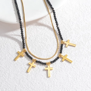 Double-layer necklace featuring a gold snake chain and black beads with five cross pendants