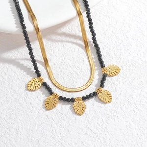 Double-layer 18k gold plated necklace with black beads and monstera leaf pendants