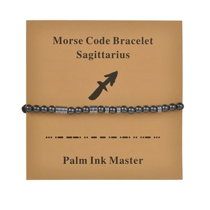 Close-up of Sagittarius Morse code bracelet with obsidian beads on card display