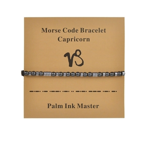 Detail of Capricorn morse code bracelet with black obsidian beads on display card