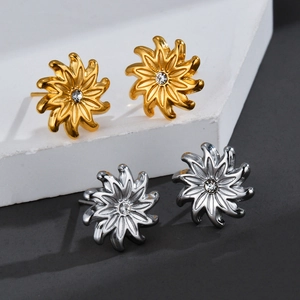 Elegant gold and silver sunflower stud earrings with sparkling crystal center on stone