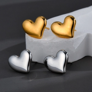 Minimalist heart-shaped stainless steel earrings in gold and silver finish on stone pedestals