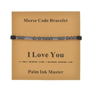 Morse code bracelet with black cord and silver beads on 'I Love You' card display