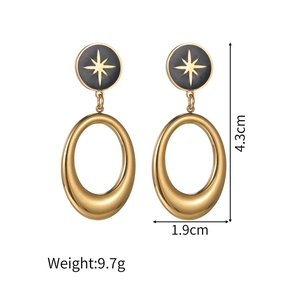 Detailed view of hollow gold oval earrings with black enamel star stud motifs